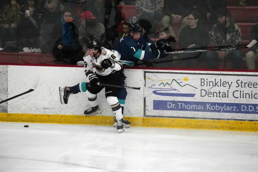 Kenai Rivers Carter McCormick checks Anchorages Christian Theberge away from the puck at the Soldotna Regional Sports Complex in Soldotna, Alaska, on Friday, Jan. 25, 2024. (Jake Dye/Peninsula Clarion)