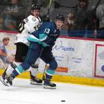 Kenai Rivers Tiziano Pauchard and Anchorages Luke Anderson battle for the puck at the Soldotna Regional Sports Complex in Soldotna, Alaska, on Friday, Jan. 25, 2024. (Jake Dye/Peninsula Clarion)