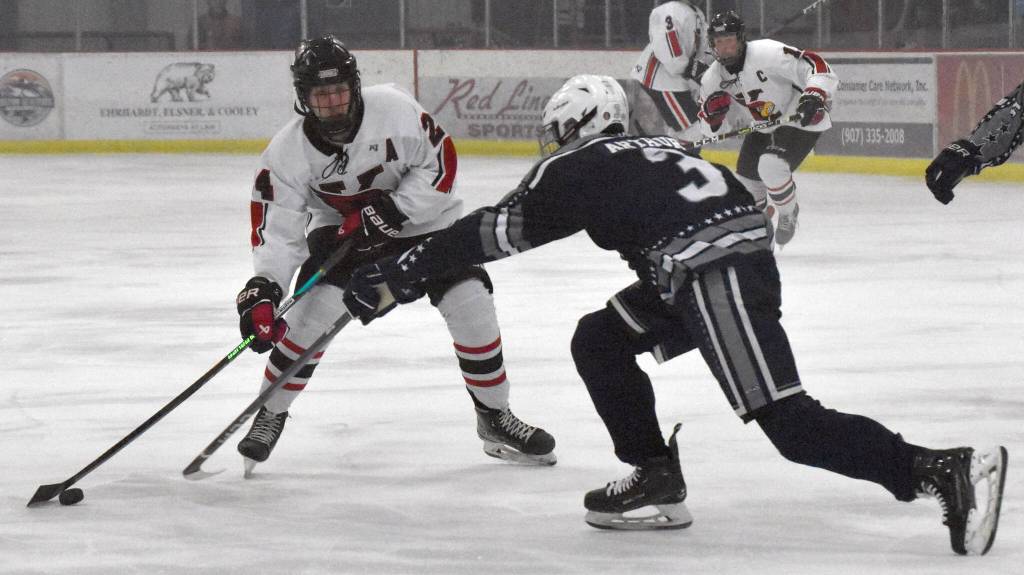 Kenai Centrals Avery Martin protects the pucks from Soldotnas Andrew Arthur on Friday, Jan. 26, 2024, at the Kenai Multi-Purpose Facility in Kenai, Alaska. (Photo by Jeff Helminiak/Peninsula Clarion)