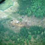 Virgil Dahler photo courtesy of the KPC historical photo archive
This aerial view from about 1950 shows Jack Keelers home on his homestead east of Soldotna. The stream to the left is Soldotna Creek, and the bridge across the stream probably allowed early access to the Mackey Lakes area. The road to the right edge of the photo leads to the Sterling Highway.