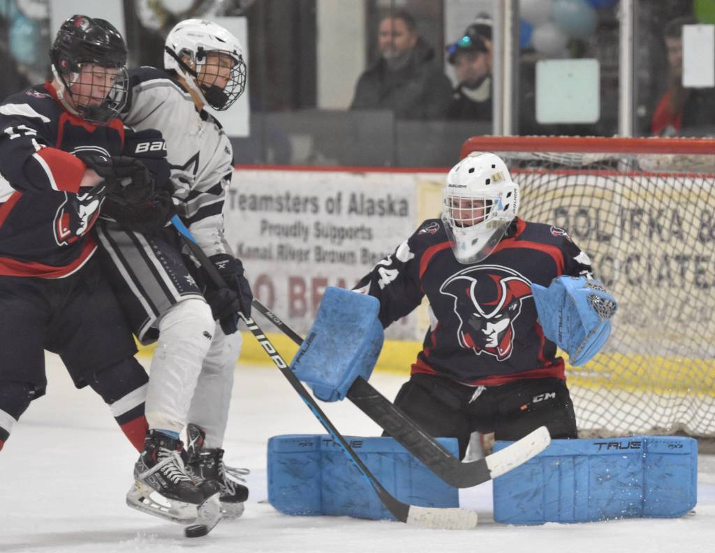 North Poles William Slater and Soldotnas Daniel Heath battle in front of North Pole goalie Daniel Rady on Thursday, Feb. 1, 2024, at the Division II state hockey tournament at the Soldotna Regional Sports Complex in Soldotna, Alaska. (Photo by Jeff Helminiak/Peninsula Clarion)