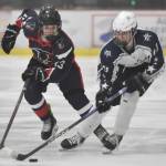 Soldotnas Boone Theiler carries the puck in front of North Poles Max Earl on Thursday, Feb. 1, 2024, at the Division II state hockey tournament at the Soldotna Regional Sports Complex in Soldotna, Alaska. (Photo by Jeff Helminiak/Peninsula Clarion)