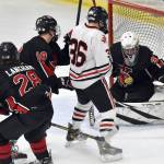 Kenai Central goalie Evyn Witt makes a save in front of Juneau-Douglas:Yadaa.at Kales Elliot Welch on Thursday, Feb. 1, 2024, at the Division II state hockey tournament at the Soldotna Regional Sports Complex in Soldotna, Alaska. (Photo by Jeff Helminiak/Peninsula Clarion)