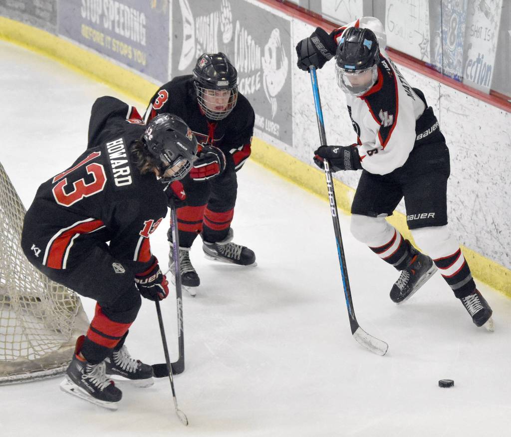 Kenai Centrals Will Howard and Ethan Tree defend Houstons Daniel Matveev at the Division II state tournament Friday, Feb. 2, 2024, at the Soldotna Regional Sports Complex in Soldotna, Alaska. (Photo by Jeff Helminiak/Peninsula Clarion)