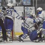 Palmer piles on Elijah Von Gunten after he scored his second of two goals in the final minute to tie the game with Soldotna at 3 at the Division II state tournament Friday, Feb. 2, 2024, at the Soldotna Regional Sports Complex in Soldotna, Alaska. (Photo by Jeff Helminiak/Peninsula Clarion)