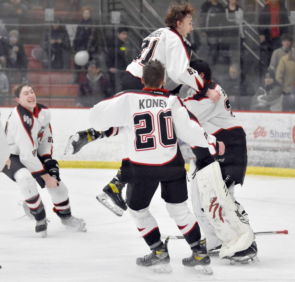 Houston mobs goalie Ari Burnside after winning the Division II state hockey tournament Saturday, Feb. 3, 2024, at the Soldotna Regional Sports Complex in Soldotna, Alaska. (Photo by Jeff Helminiak/Peninsula Clarion)