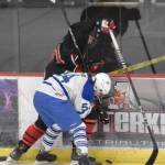 Kenai Centrals Vincent Steen and Palmers Peyton Neumann battle for the puck at the Division II state hockey tournament Saturday, Feb. 3, 2024, at the Soldotna Regional Sports Complex in Soldotna, Alaska. (Photo by Jeff Helminiak/Peninsula Clarion)