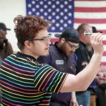 Quinton Mathis readies to loose a dart at the Elks Lodge in Kenai, Alaska, on Saturday, Feb. 3, 2024. (Jake Dye/Peninsula Clarion)