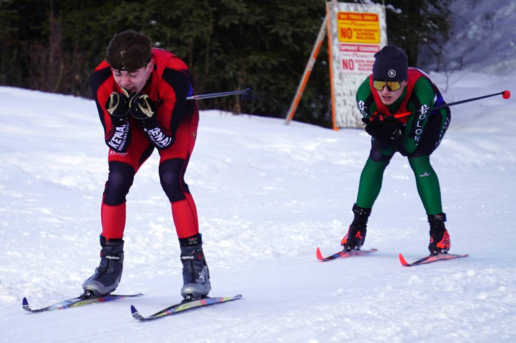 Kenai Centrals Greg Fallon leads Colonys Raven Spangler as both approach the finish chute during the Region III Boys 7.5K Classic Race at Tsalteshi Trails near Soldotna, Alaska, on Saturday, Feb. 10, 2024. (Jake Dye/Peninsula Clarion)