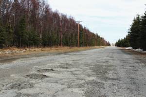 Potholes are seen on Wildwood Drive on Thursday, April 22, 2021, in Kenai, Alaska. (Ashlyn OHara/Peninsula Clarion)