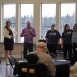 Aspen Creek Senior Living CEO Doug Clegg, with the microphone, calls up members of the Soldotna locations staff during a grand opening event at Aspen Creek Senior Living in Soldotna, Alaska, on Friday, Feb. 9, 2024. (Jake Dye/Peninsula Clarion)