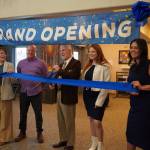 Soldotna Mayor Paul Whitney, center, and representatives of Aspen Creek Senior Living celebrate a ribbon cutting during a grand opening event at Aspen Creek Senior Living in Soldotna, Alaska, on Friday, Feb. 9, 2024. (Jake Dye/Peninsula Clarion)