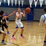 Cook Inlet Academys Owen Braband makes a pass to Trent Waller in front of an attempted block by Aniaks Ralph Steeves during a basketball game at Cook Inlet Academy in Soldotna, Alaska, on Tuesday, Feb. 13, 2024. (Jake Dye/Peninsula Clarion)