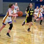 Cook Inlet Academys Rebekah Dillingham outpaces Aniaks Maddison Steeves as she dribbles down the court during a basketball game at Cook Inlet Academy in Soldotna, Alaska, on Tuesday, Feb. 13, 2024. (Jake Dye/Peninsula Clarion)