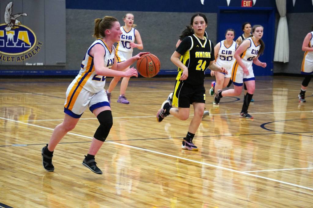 Cook Inlet Academys Rebekah Dillingham outpaces Aniaks Maddison Steeves as she dribbles down the court during a basketball game at Cook Inlet Academy in Soldotna, Alaska, on Tuesday, Feb. 13, 2024. (Jake Dye/Peninsula Clarion)