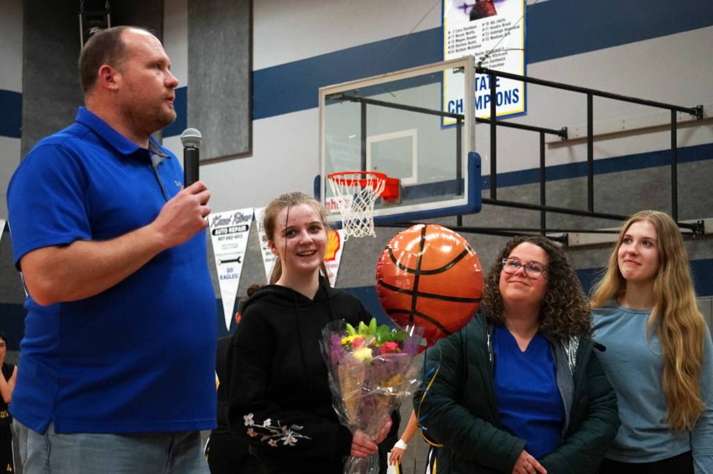 Cook Inlet Academys Mackenzie Carson stands with her family and coach Josh Hawley as shes honored during senior night festivities at Cook Inlet Academy in Soldotna, Alaska, on Tuesday, Feb. 13, 2024. (Jake Dye/Peninsula Clarion)