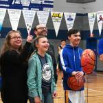 Cook Inlet Academys Nehemiah Barnes stands with his family and coach Ben McGarry as hes honored during senior night festivities at Cook Inlet Academy in Soldotna, Alaska, on Tuesday, Feb. 13, 2024. (Jake Dye/Peninsula Clarion)