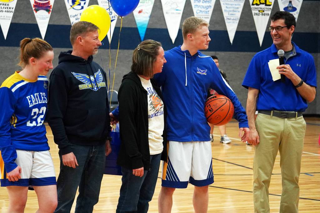 Cook Inlet Academys Jeremy Dillingham stands with his family and coach Ben McGarry as hes honored during senior night festivities at Cook Inlet Academy in Soldotna, Alaska, on Tuesday, Feb. 13, 2024. (Jake Dye/Peninsula Clarion)