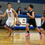 Cook Inlet Academys Alex McGarry outpaces Aniaks Marshall Dallmann and Rylan Lang as he dribbles down the court during a basketball game at Cook Inlet Academy in Soldotna, Alaska, on Tuesday, Feb. 13, 2024. (Jake Dye/Peninsula Clarion)