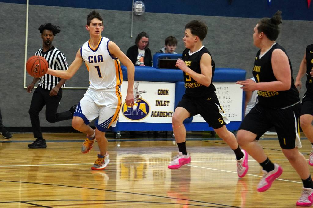 Cook Inlet Academys Alex McGarry outpaces Aniaks Marshall Dallmann and Rylan Lang as he dribbles down the court during a basketball game at Cook Inlet Academy in Soldotna, Alaska, on Tuesday, Feb. 13, 2024. (Jake Dye/Peninsula Clarion)