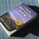 A copy of Tom Kizzias Cold Mountain Path rests on a table on Thursday in Juneau. (Ashlyn OHara/Peninsula Clarion)