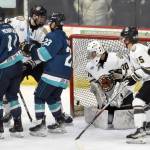 Anchorage Wolverines forward Taisetsu Ushio knocks the puck past Kenai River Brown Bears goalie AJ Reyelts on Saturday, March 2, 2024, at the Soldotna Regional Sports Complex in Soldotna, Alaska. (Photo by Jeff Helminiak/Peninsula Clarion)