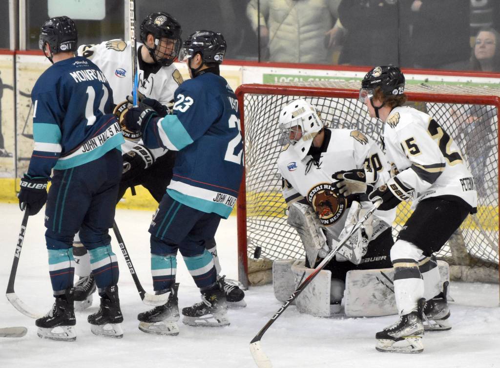 Anchorage Wolverines forward Taisetsu Ushio knocks the puck past Kenai River Brown Bears goalie AJ Reyelts on Saturday, March 2, 2024, at the Soldotna Regional Sports Complex in Soldotna, Alaska. (Photo by Jeff Helminiak/Peninsula Clarion)