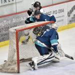 Anchorage Wolverines defenseman Trent Powell, who is from Soldotna, and Kenai River Brown Bears forward Landon MacDonald battle for the puck behind Wolverines goalie Vaughn Makar on Saturday, March 2, 2024, at the Soldotna Regional Sports Complex in Soldotna, Alaska. (Photo by Jeff Helminiak/Peninsula Clarion)