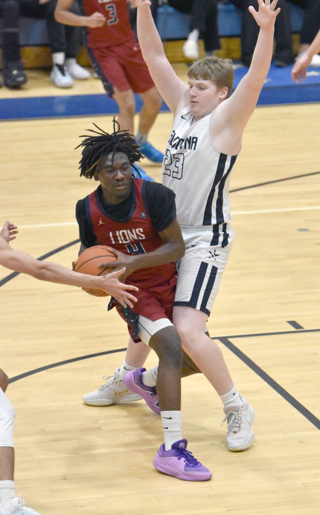Darian Igwacho of Mountain City Christian Academy is pressured by Soldotnas Theo Huff on Thursday, March 7, 2024, at the Northern Lights Conference tournament at Soldotna High School in Soldotna, Alaska. (Photo by Jeff Helminiak/Peninsula Clarion)