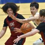 Serge Duchatellier and Lukas Underhile of Mountain City Christian Academy and Cameron LaRoque of Soldotna battle for the ball Thursday, March 7, 2024, at the Northern Lights Conference tournament at Soldotna High School in Soldotna, Alaska. (Photo by Jeff Helminiak/Peninsula Clarion)