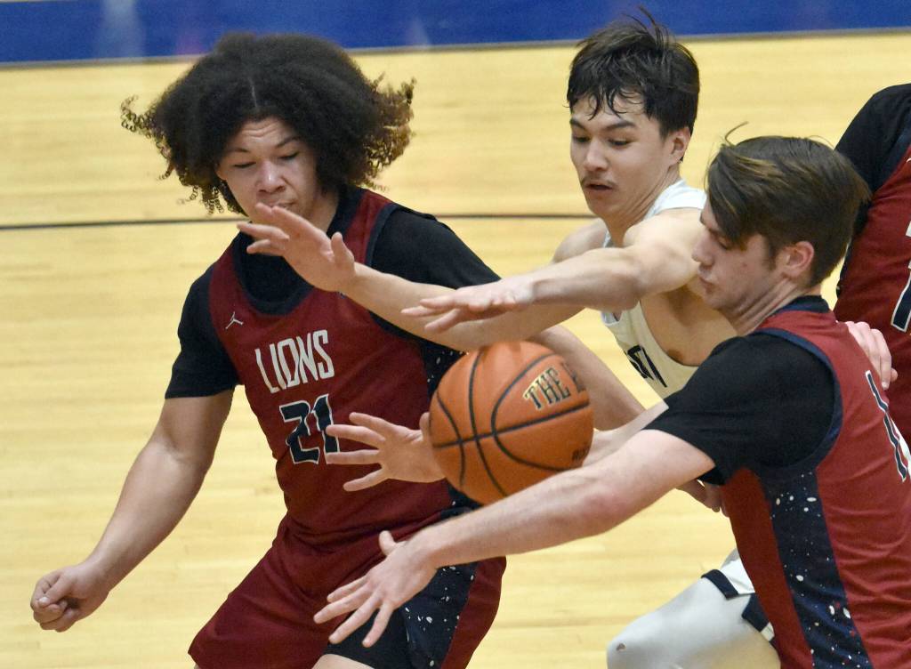 Serge Duchatellier and Lukas Underhile of Mountain City Christian Academy and Cameron LaRoque of Soldotna battle for the ball Thursday, March 7, 2024, at the Northern Lights Conference tournament at Soldotna High School in Soldotna, Alaska. (Photo by Jeff Helminiak/Peninsula Clarion)