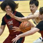 Serge Duchatellier and Lukas Underhile of Mountain City Christian Academy and Cameron LaRoque of Soldotna battle for the ball Thursday, March 7, 2024, at the Northern Lights Conference tournament at Soldotna High School in Soldotna, Alaska. (Photo by Jeff Helminiak/Peninsula Clarion)