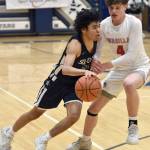 Soldotnas Izaiah Gilbert drives on Wasillas Ledger Lusk on Friday, March 8, 2024, at the Northern Lights Conference tournament at Soldotna High School in Soldotna, Alaska. (Photo by Jeff Helminiak/Peninsula Clarion)