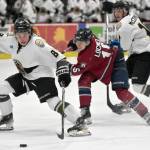 Kenai River Brown Bears forward Dylan Contreras protects the puck from Fairbanks Ice Dogs defenseman Ingus Locmelis on Saturday, March 16, 2024, at the Soldotna Regional Sports Complex in Soldotna, Alaska. (Photo by Jeff Helminiak/Peninsula Clarion)