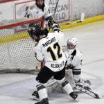 Kenai River Brown Bears defenseman Jacob Margarit and goalie AJ Reyelts scramble to keep the puck out of the net Saturday, March 16, 2024, at the Soldotna Regional Sports Complex in Soldotna, Alaska. (Photo by Jeff Helminiak/Peninsula Clarion)