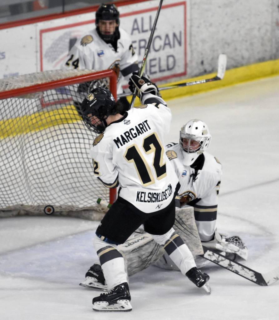 Kenai River Brown Bears defenseman Jacob Margarit and goalie AJ Reyelts scramble to keep the puck out of the net Saturday, March 16, 2024, at the Soldotna Regional Sports Complex in Soldotna, Alaska. (Photo by Jeff Helminiak/Peninsula Clarion)