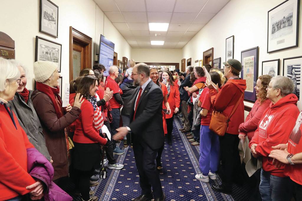 State Sen. Jesse Kiehl, a Juneau Democrat, greets educators and other people rallying in a hallway of the Alaska State Capitol just before the Legislatures override vote on Senate Bill 140 on Monday, March 18, 2024. (Mark Sabbatini / Juneau Empire)