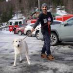 Maggie is escorted into a free spay/neuter clinic at the Moose Pass Fire Station in Moose Pass, Alaska, on Thursday, March 21, 2024. (Jake Dye/Peninsula Clarion)