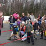 Organizers take a selfie with a crowd of children and families moments before a hunt for Easter eggs during the Easter Eggstravaganza at Nikiski Community Recreation Center in Nikiski, Alaska, on Saturday, March 23, 2024. (Jake Dye/Peninsula Clarion)