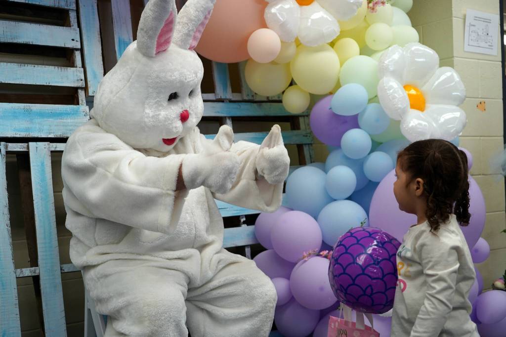 The Easter Bunny gives thumbs up to Juniper Parrish during the Easter Eggstravaganza at Nikiski Community Recreation Center in Nikiski, Alaska, on Saturday, March 23, 2024. (Jake Dye/Peninsula Clarion)