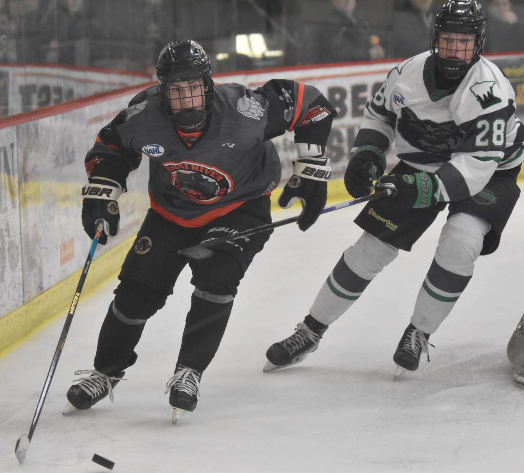 Kenai River Brown Bears forward Andy Larson works behind the net against Hawke Huff of the Minnesota Wilderness on Saturday, March 23, 2024, at the Soldotna Regional Sports Complex in Soldotna, Alaska. (Photo by Jeff Helminiak/Peninsula Clarion)