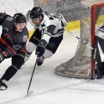 Roope Tuomioksa of the Kenai River Brown Bears attacks Payton Nelson and goalie Nick Erickson of the Minnesota Wilderness on Saturday, March 23, 2024, at the Soldotna Regional Sports Complex in Soldotna, Alaska. (Photo by Jeff Helminiak/Peninsula Clarion)