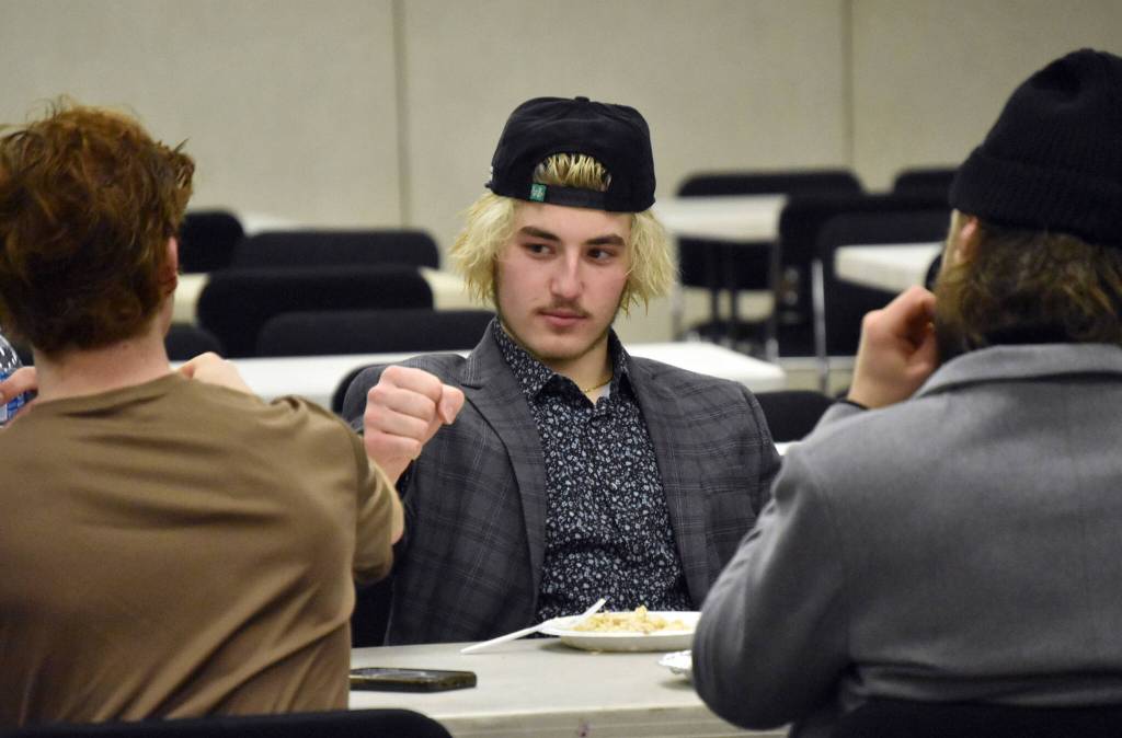 William Esterbrooks of the Kenai River Brown Bears eats a postgame meal with teammates at the Soldotna Regional Sports Complex in Soldotna, Alaska, on Friday, March 29, 2024. (Photo by Jeff Helminiak/Peninsula Clarion)