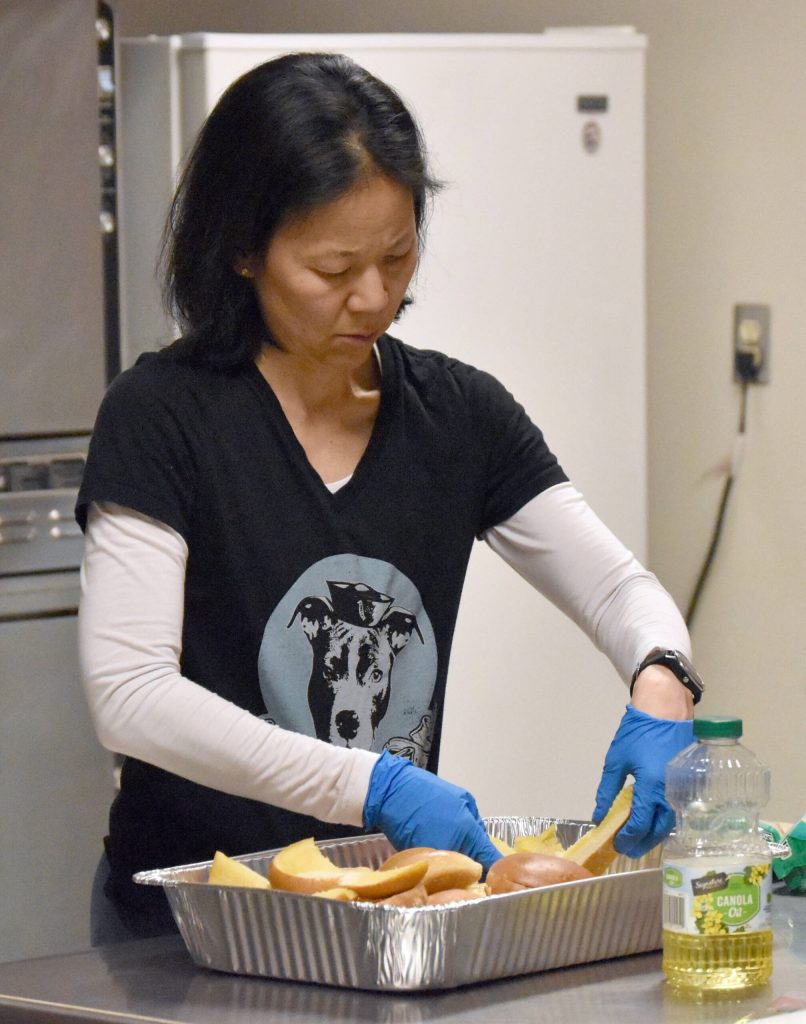 Candace Nakagawa, Co-Director of Sports Science, Strength and Conditioning for the Kenai River Brown Bears, prepares a postgame meal for the team at the Soldotna Regional Sports Complex in Soldotna, Alaska, on Friday, March 29, 2024. (Photo by Jeff Helminiak/Peninsula Clarion)
