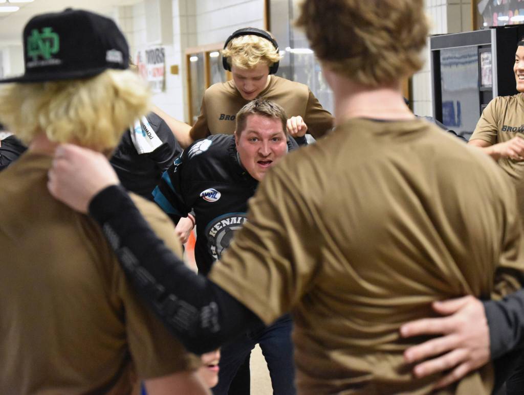 Nick Symonds, a billet parent for the Brown Bears, helps the team finish its warmup at the Soldotna Regional Sports Complex in Soldotna, Alaska, on Friday, March 29, 2024. (Photo by Jeff Helminiak/Peninsula Clarion)