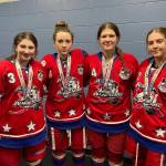 Lily Langham of Kenai Central High School and Brooklyn Larsen, Rylie Thompson and Ava Fabian of Soldotna High School, stand for a photo with their medals after competing in the USA Hockey National Championships as part of the Alaska All Stars 19U Division 2A hockey team. (photo provided)