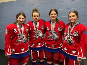Lily Langham of Kenai Central High School and Brooklyn Larsen, Rylie Thompson and Ava Fabian of Soldotna High School, stand for a photo with their medals after competing in the USA Hockey National Championships as part of the Alaska All Stars 19U Division 2A hockey team. (photo provided)