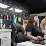 Vanessa Uei checks in guests during a grand opening for AK Wellness & Tanning in Kenai, Alaska, on Saturday, April 6, 2024. (Jake Dye/Peninsula Clarion)