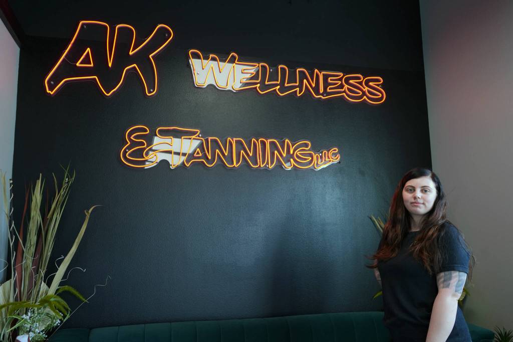 Vanessa Uei stands for a photo at AK Wellness & Tanning in Kenai, Alaska, on Saturday, April 6, 2024. (Jake Dye/Peninsula Clarion)