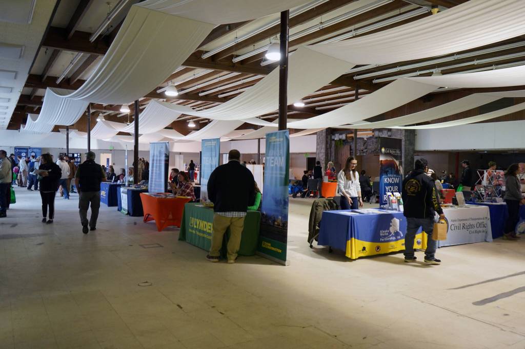 Attendees mill between vendor tables during the Kenai Peninsula Job and Career Fair in Kenai, Alaska, on Wednesday, April 10, 2024. (Jake Dye/Peninsula Clarion)